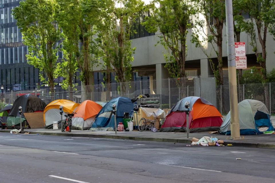 Tents set up by unhoused people on sidewalk in San Francisco, California.
